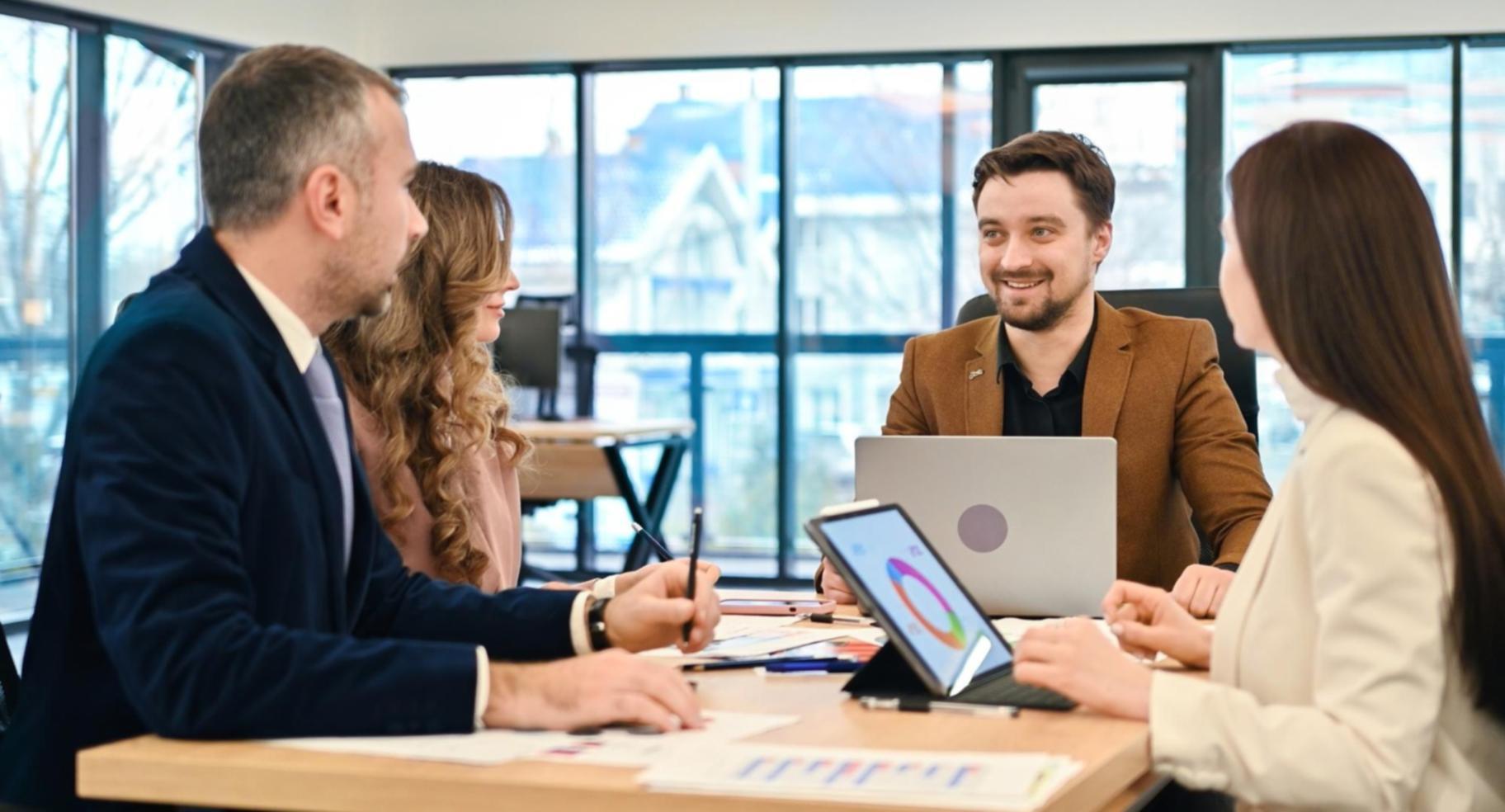 Person studying financial materials with various learning resources spread across a desk